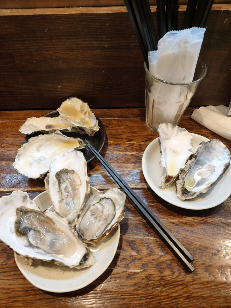 食べ終わった牡蠣の殻が、皿の上に山積みにされている様子。